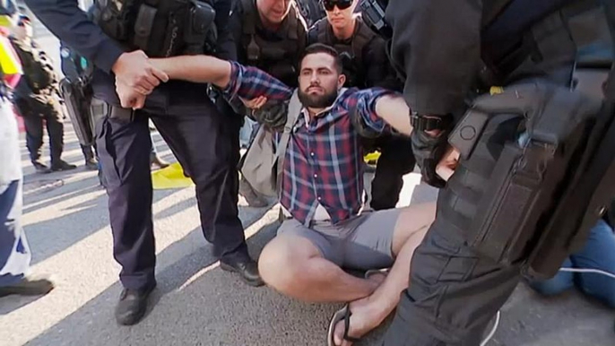 Extinction Rebellion protesters arrested after blocking lanes in Brisbane