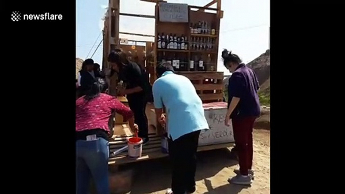 Chilean students paint greenhouse made from community waste