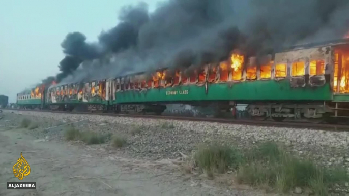 Funerals begin as town mourns victims of Pakistan train fire