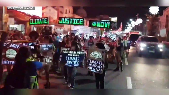 Youth groups parade recycled lanterns for climate justice