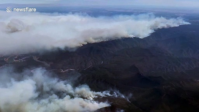 Aerial view from plane window shows wall of smoke from Australia's bushfires at 25,000 feet