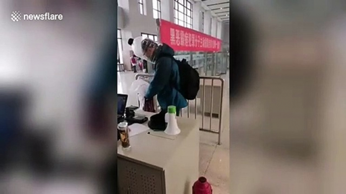 Chinese man spotted covering his head with plastic bottle at train station during coronavirus outbreak