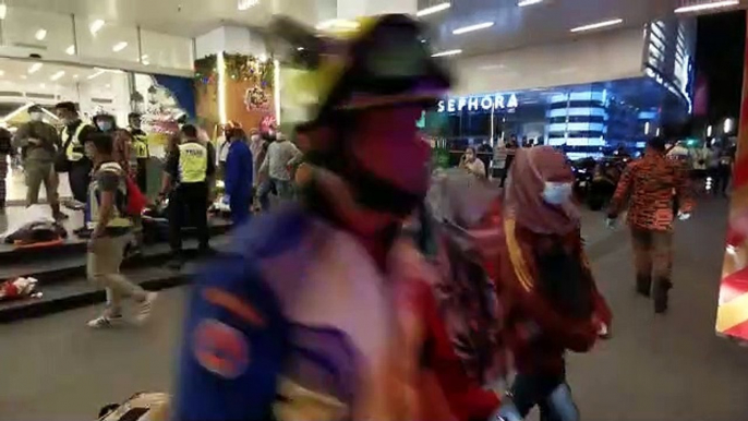 Rescue personnel tending to injured passengers at KLCC station