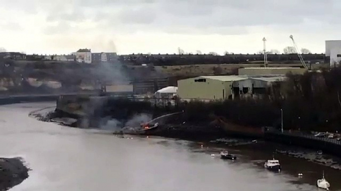 Fire fighters extinguish boat fire in Deptford