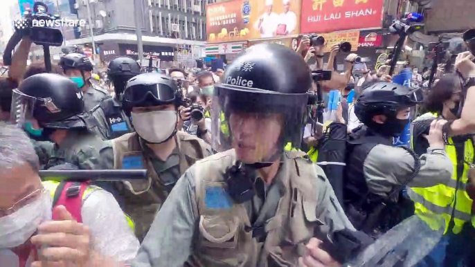 Hong Kong police brutally throw young journalist to the ground before pepper-spraying him