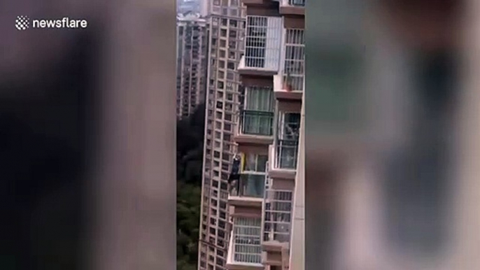 Chinese children captured playing on angled roof of high-rise building