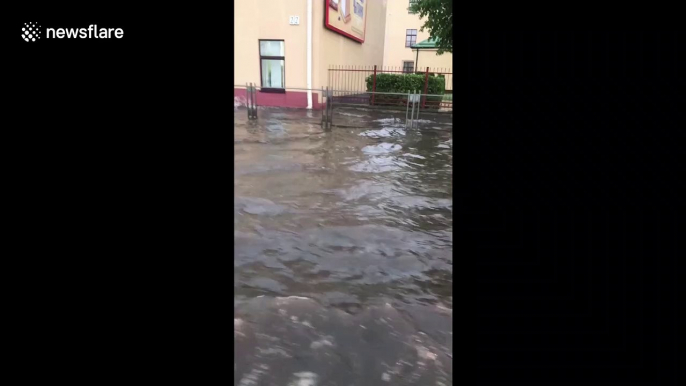 Vehicles drive through flooded streets as strong storm hits Belarus capital