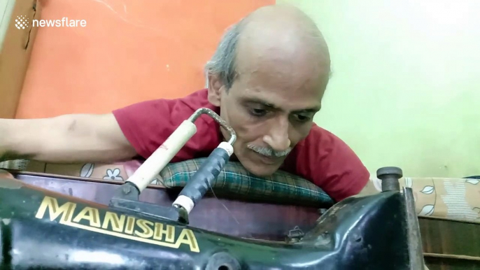 Paralysed man in India works sewing machine from bed to support his family