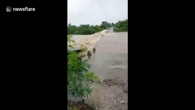 Terrifying moment truck swept into fast-flowing river during heavy floods in India