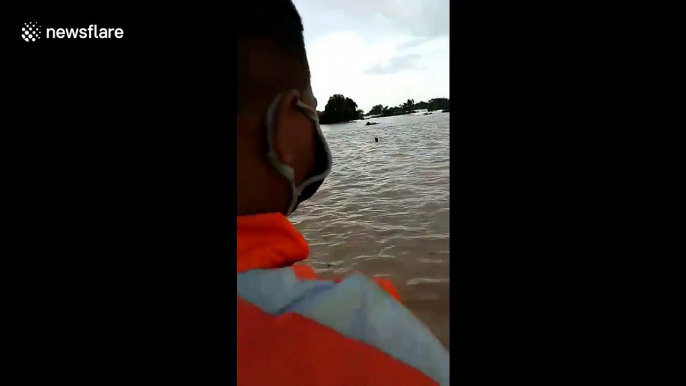 Patrolling officials jump into floodwater to rescue drowning residents in India