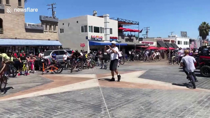 Bicyclist almost crashes into cop after popping wheelie in San Diego