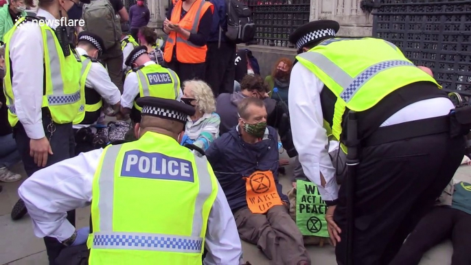 Extinction Rebellion protesters glue themselves outside UK Parliament