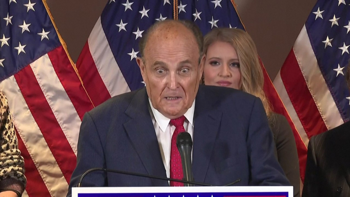 What appears to be hair dye runs down his face as Rudy Giuliani sweats election results