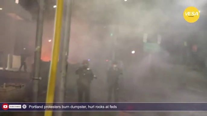 Portland protesters burn dumpster, hurl rocks at feds