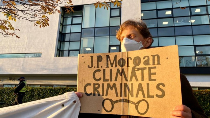 Protestors march in front of JP Morgan in Glasgow