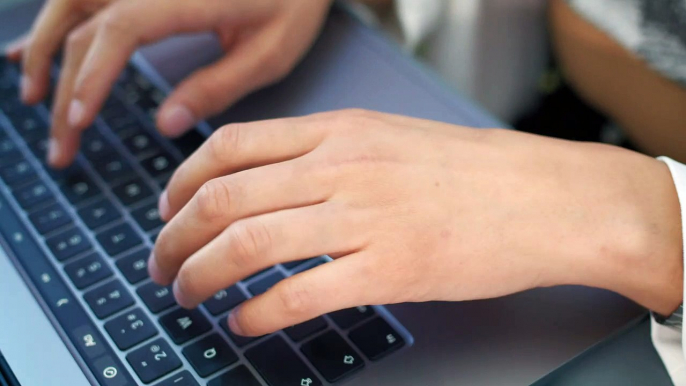 -hands-of-a-woman-typing-on-a-laptop-42662
