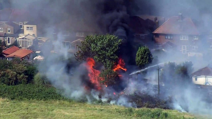 Heatwave: Fires burn down buildings in East London