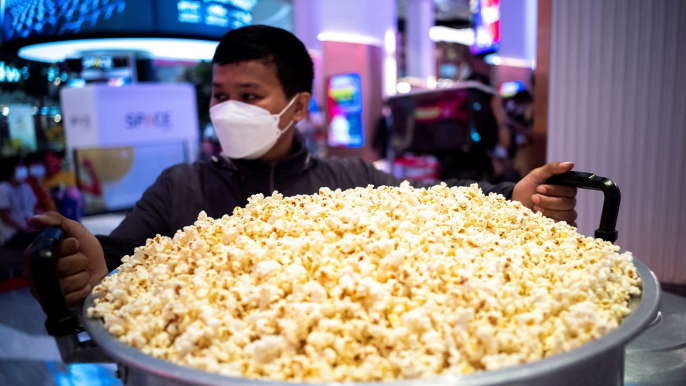 Customers fill steel vats, cardboard boxes with Thai cinema’s all-you-can-eat popcorn