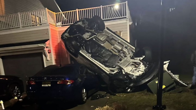 Stolen car flips off embankment and lands on house in New Jersey