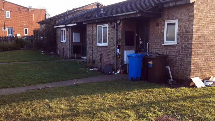 Photo among floral tributes outside Sheffield house where man tragically died in fire along with pet dogs