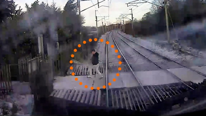 High-speed train narrowly misses pedestrian crossing tracks after ignoring warnings