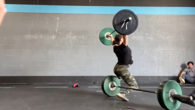 Barbell Rolls on Floor and Hits Woman From Behind While She Does Weightlifting at Gym