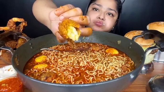 Mukbang noodles, a large bowl, sunny side up eggs, fried shrimp with chili sauce, burgers