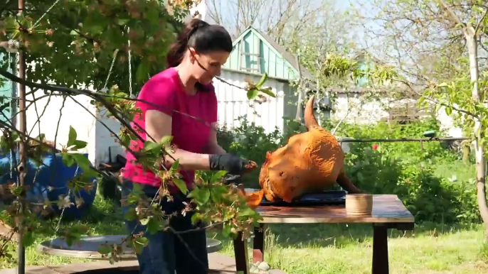 Gastronomic journey_ preparing a bull_s head on a traditional Tandoor in a rural area