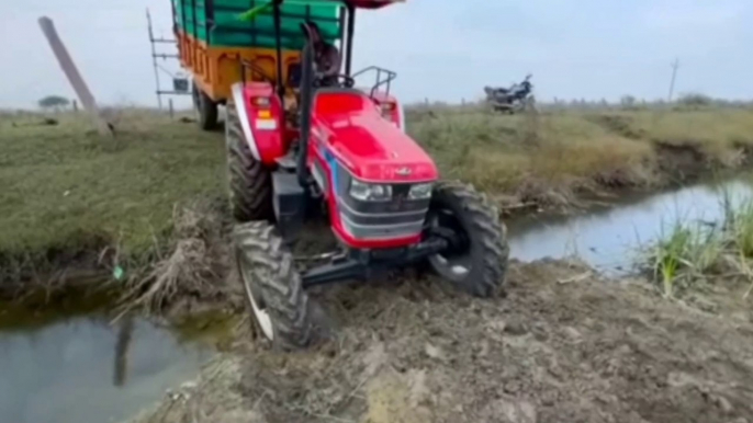 Mahindra four wheel drive tractor performance on muddy and water road // world's most dangerous driving