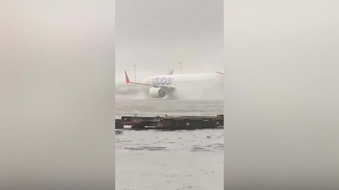 Plane battles through floods at Dubai airport as heavy rain causes cancelled flights