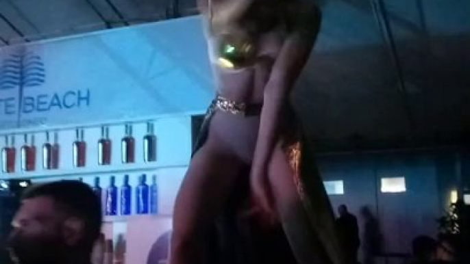 A fiery erotic dance of two girls on the bar counter.