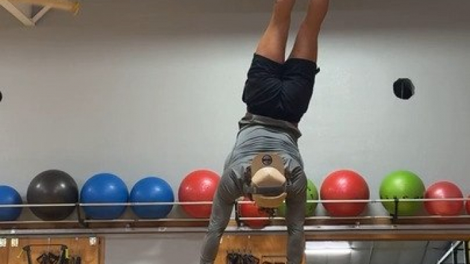 Man Attempts Handstand but Loses Balance and Falls