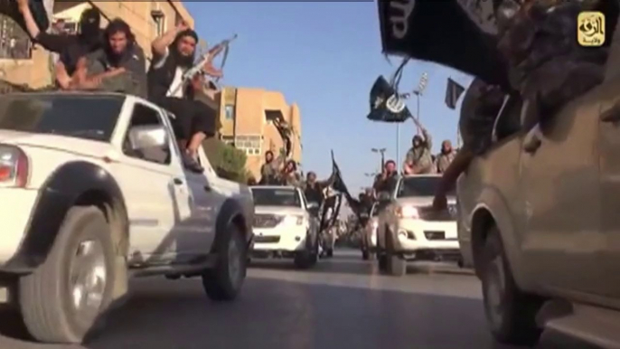 Islamic State militants parade in their Syrian stronghold