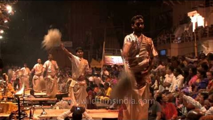 Hindu priests ceremoniously waving fly whisk during Ganga Aarti in Varanasi