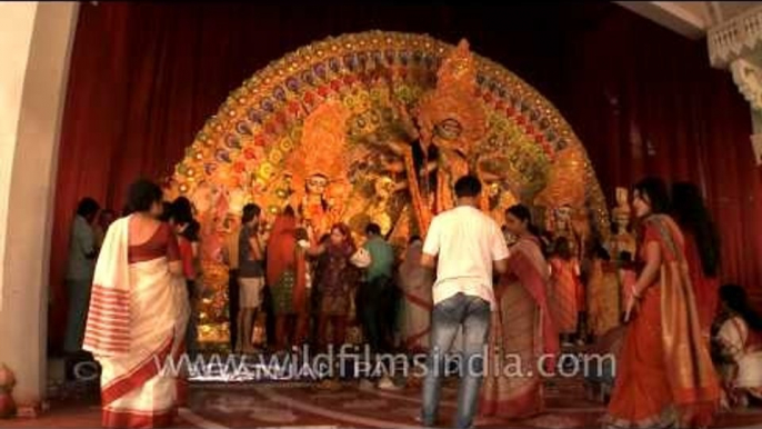 Ladies performing Durga Puja rituals