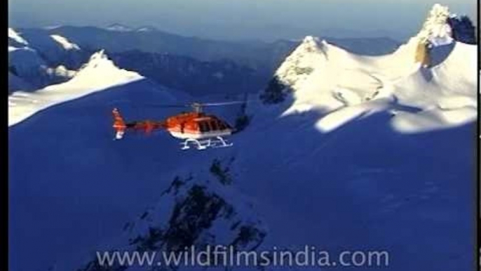 Chopper flying over the snow-capped mountains of Himalayan Range