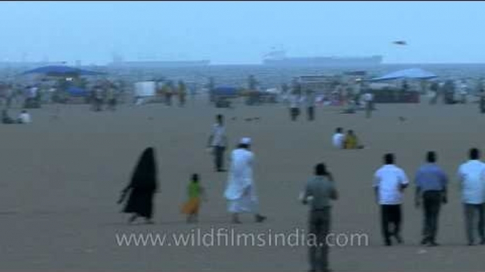 Visitors relaxing on Marina beach of chennai