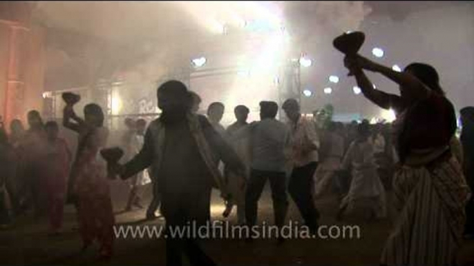 Devotees dance whilst holding aartis on Durga Puja