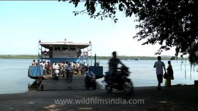 Bikes and passengers getting off a ferryboat in Goa