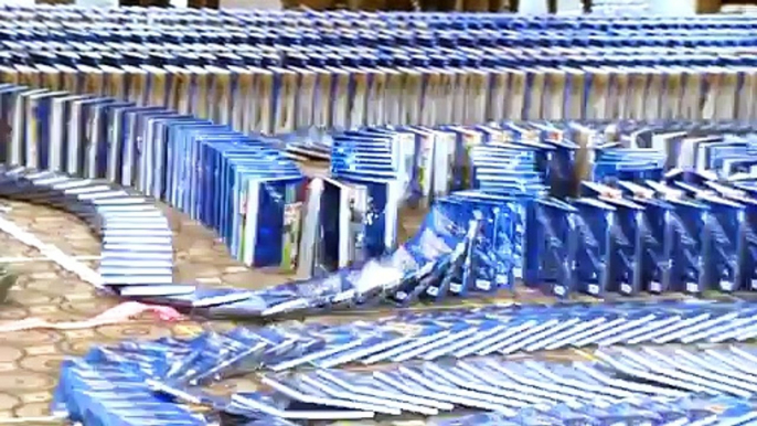 Watch thousands of copies of the Guinness World Records 2015 book topple like dominos!