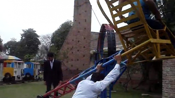 College boys having fun in the park by having a lad on the dangerous chair - funny video