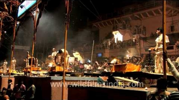 Priests performing evening Ganga aarti on the banks of Varanasi