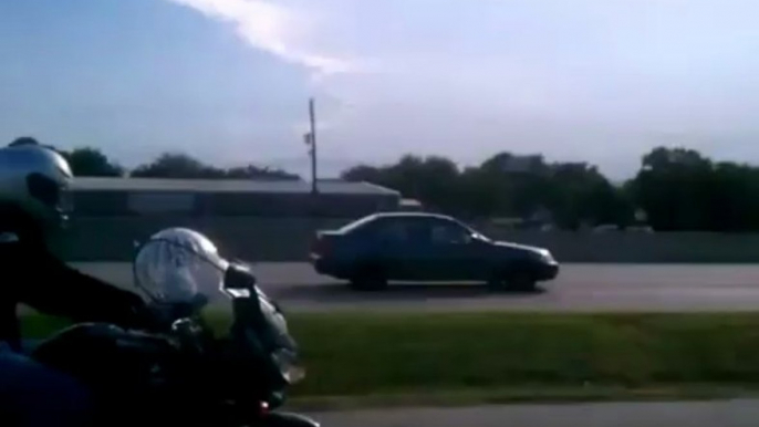 Cat rides motorcycle in a hamster ball