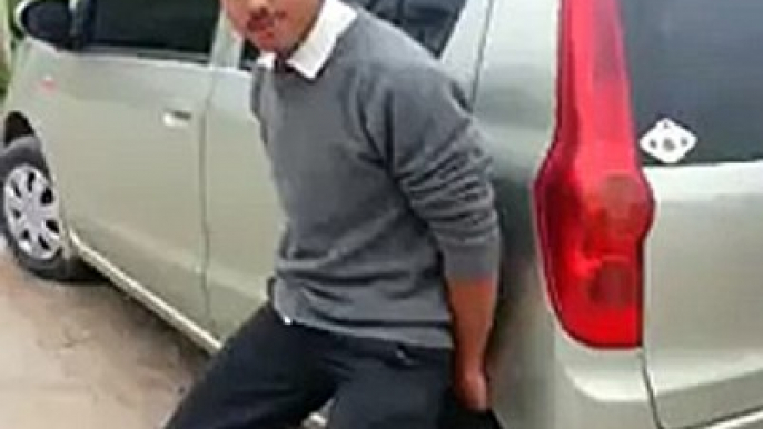 funny boy lifted a car by his hands