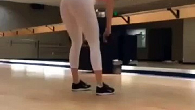 Squats in white yoga pants