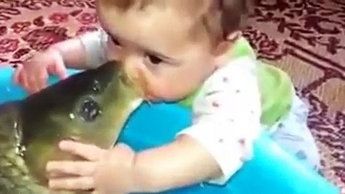 kid gives a french kiss to a fish