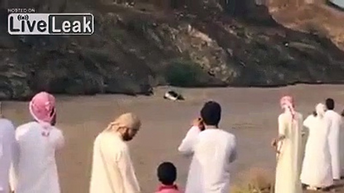 Vehicle with Arabs on top of it Drifting in Flood