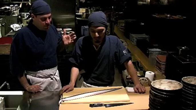 Butchering of a live eel imported from Japan