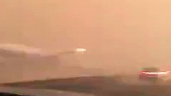 malaysia airline  plane on the other side of road during sand storm