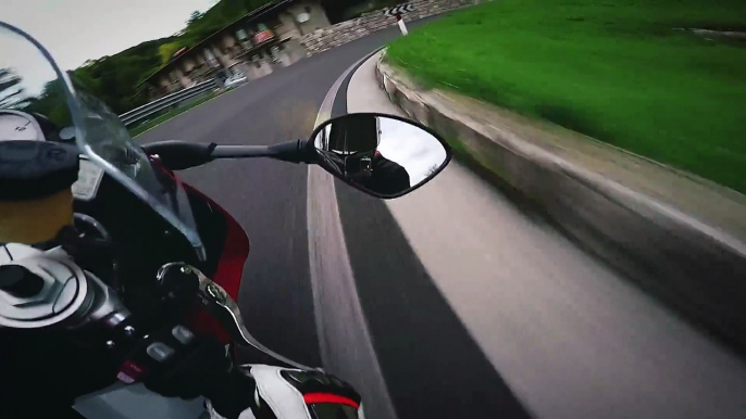 Un motard a grande vitesse sur une route de montagne avec sa moto S1000RR